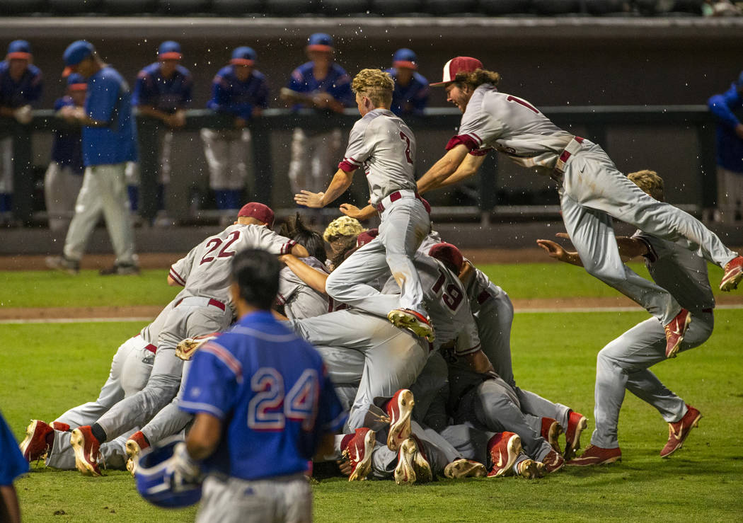 Desert Oasis players celebrate their win over Reno 9-1 during the tie-breaker game of their Cla ...