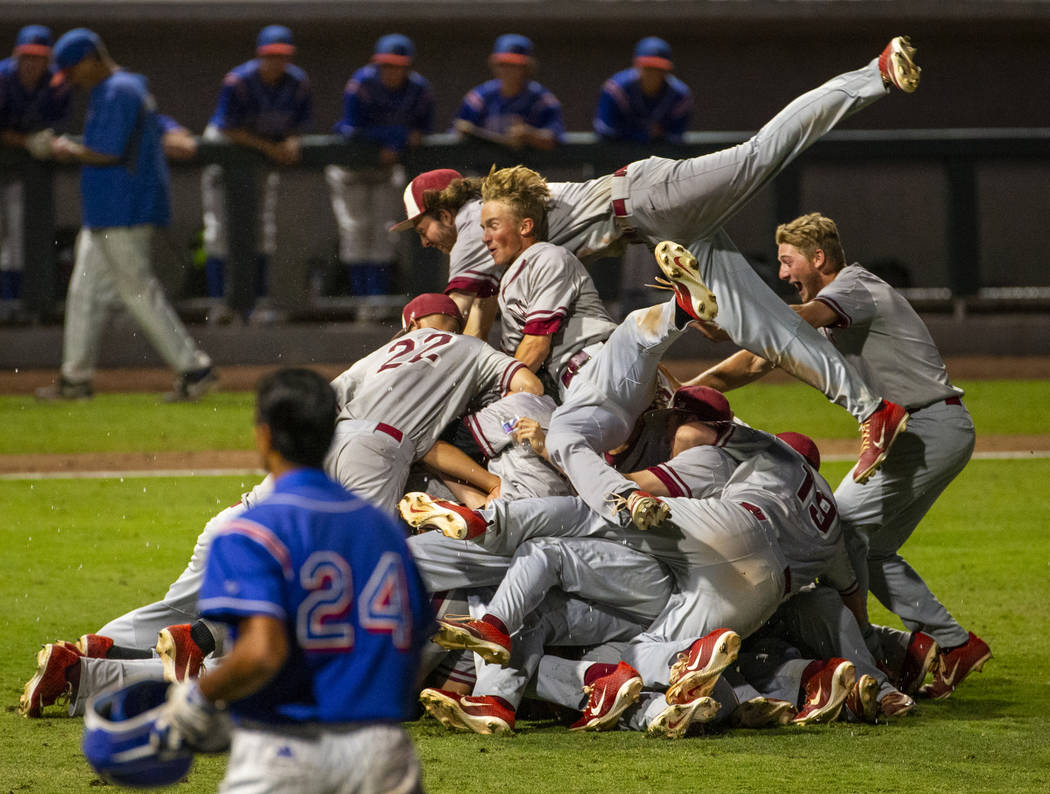 Desert Oasis players celebrate their win over Reno 9-1 during the tie-breaker game of their Cla ...