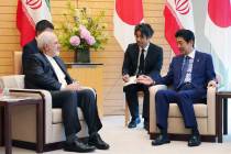Iranian Foreign Minister Mohammad Javad Zarif, left, and Japanese Prime Minister Shinzo Abe, ri ...