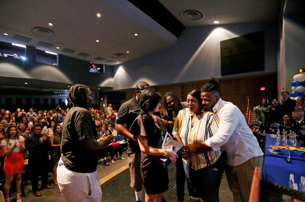 Bryan LaGrange hugs his mom Tyria Smith as she reacts to the news that she will receive a new c ...