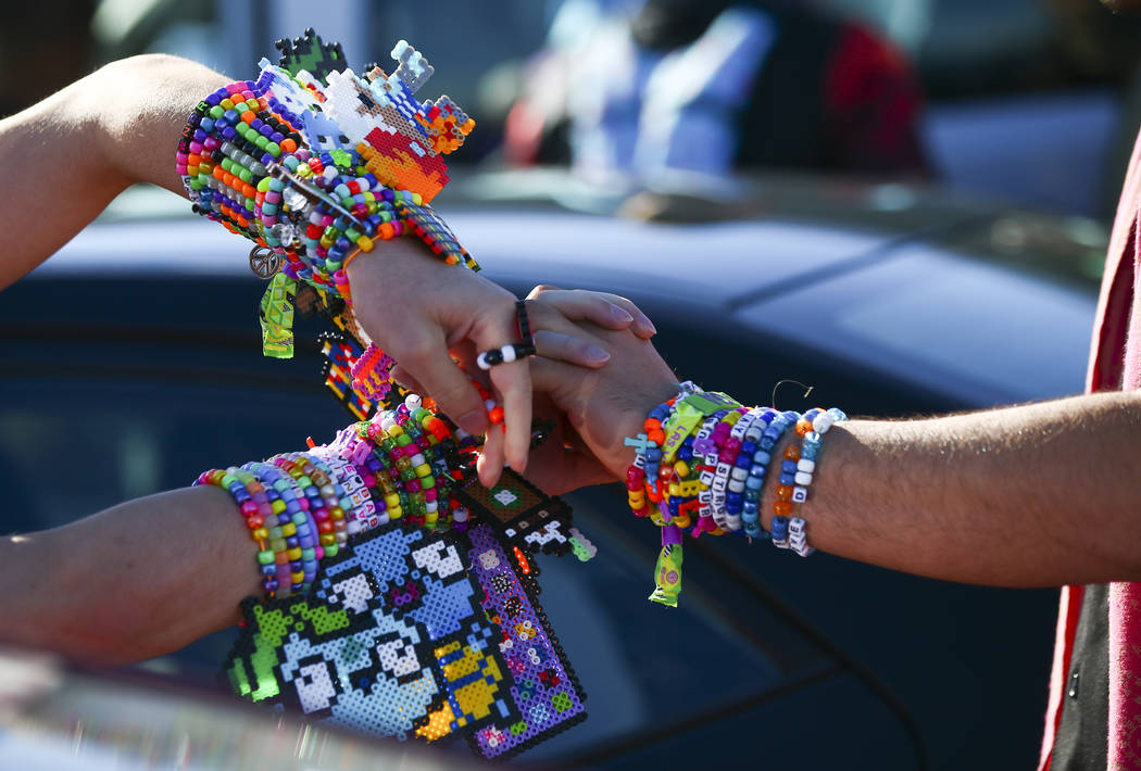 Alex Spry, of Moreno Valley, Calif., left, trades kandi with Esteban Hernandez, of N. J., as El ...