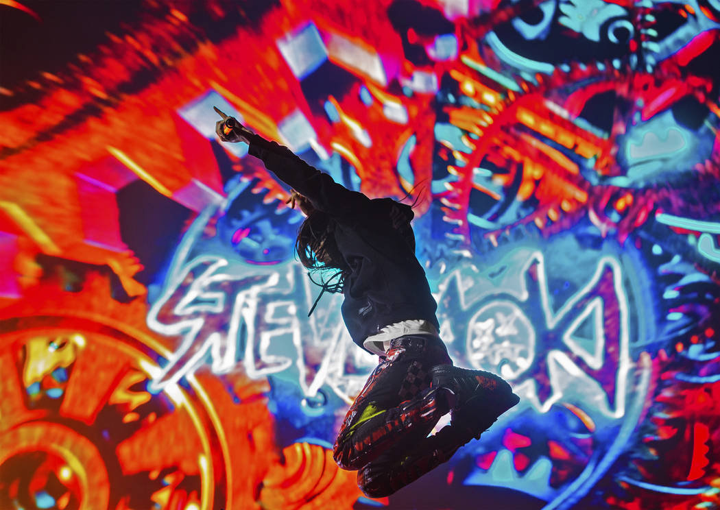 Steve Aoki leaps in the air during his performance at the Circuit Grounds stage on day three of ...