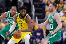 Indiana Pacers' Tyreke Evans (12) is defended by Boston Celtics' Gordon Hayward (20) during the ...