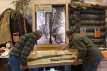 Workers from design company DiVittorio and Associates help install the new "Forgotten Winchest ...