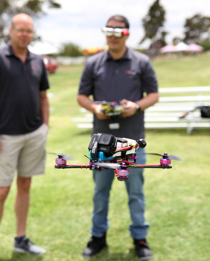 Shawn Capalingo, right, flies his custom built copia frame free style racing drone over Craig R ...