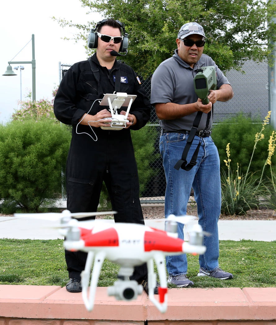 Jason Daub, a pilot in command, left, flies his Phantom IV drone as Andy Morale, director of bu ...