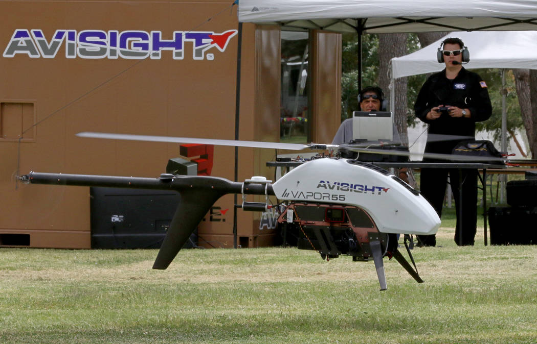 Jason Daub, a pilot in command, flies the Vapor 55 unmanned helicopter over Craig Ranch Park on ...