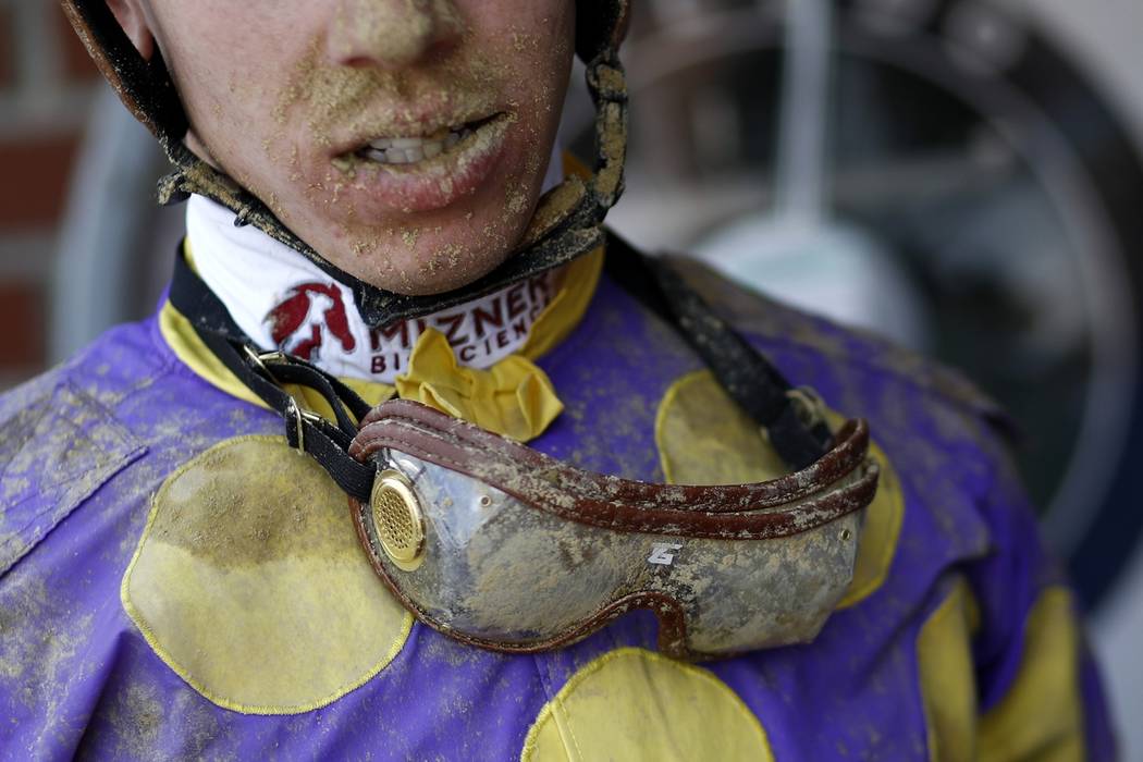 Dirt sticks to jockey Tyler Gaffalione's goggles following the day's eighth race at Pimlico Rac ...