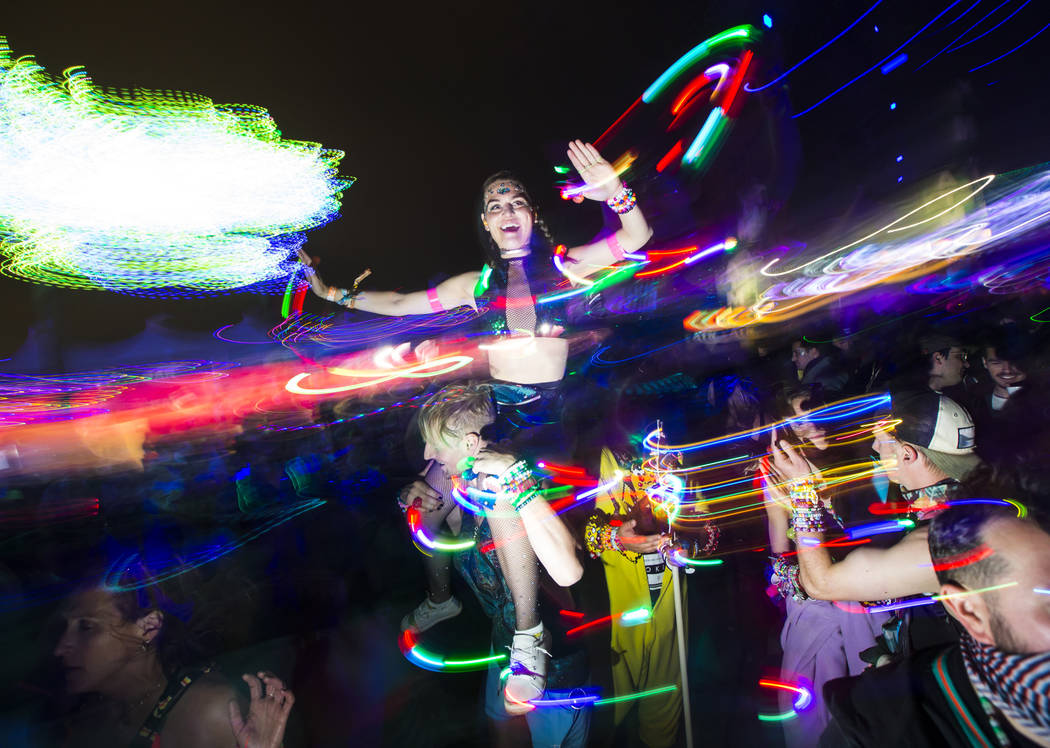 Attendees dance as Skrillex, not pictured, performs at the Circuit Grounds stage during the sec ...