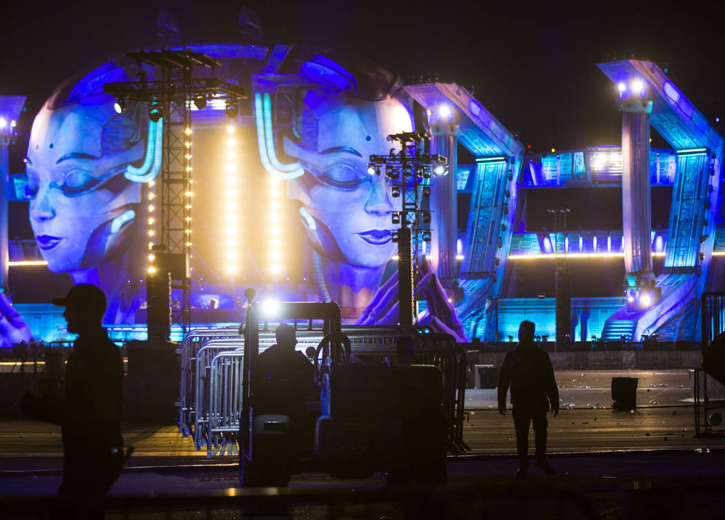 Event officials clear the area at the Kinetic Field stage after it was shut down due to high wi ...