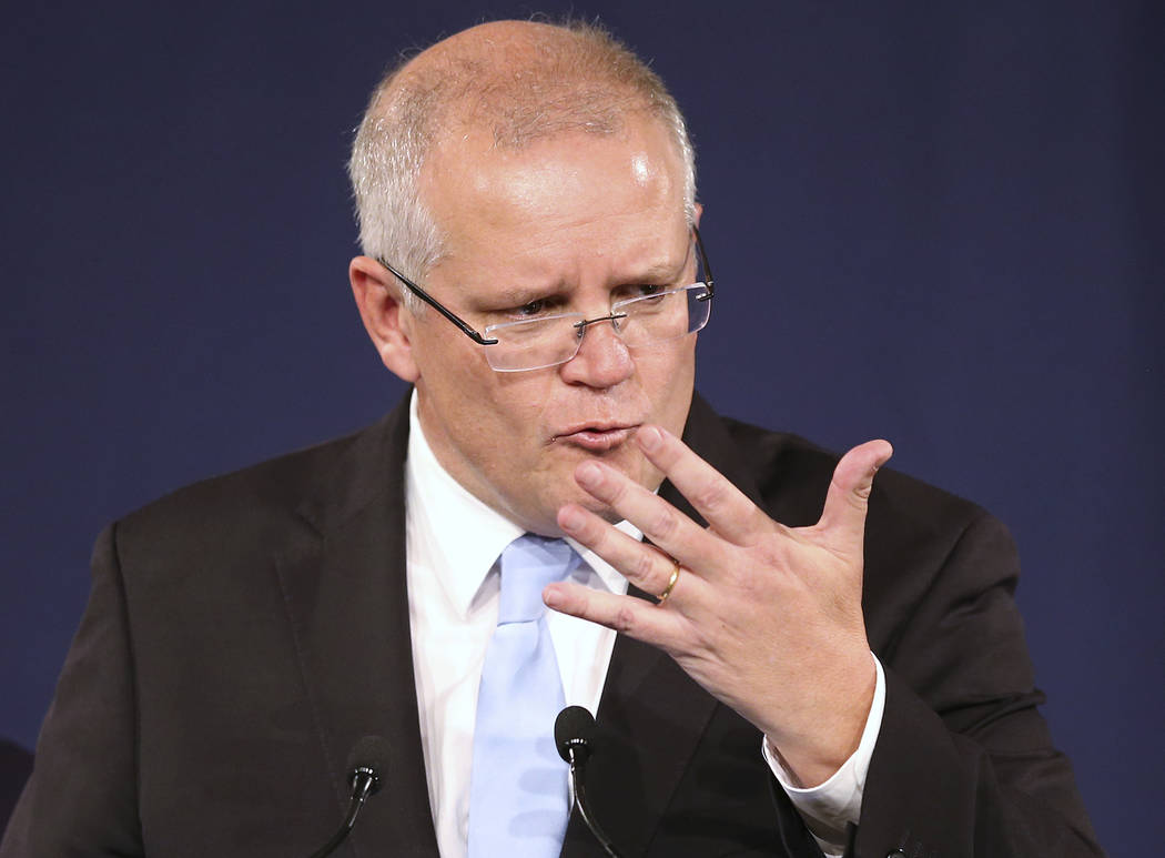 Australian Prime Minister Scott Morrison gestures as he speaks to party supporters after his op ...