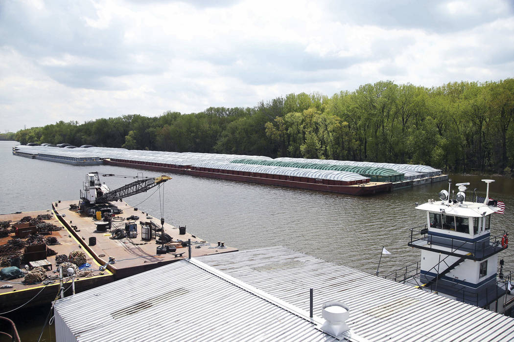 In this Tuesday, May 14, 2019 photo, barges already loaded with soy beans, potash or scrap stee ...