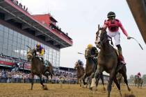 Jockey Tyler Gaffalione, right, reacts aboard War of Will, as they crosses the finish line firs ...