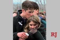 FILE - In this April 25, 1999 file photo, shooting victim Austin Eubanks hugs his girlfriend du ...