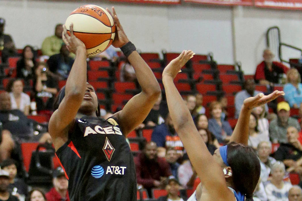 Las Vegas Aces Jackie Young (0) attempts a basket against Minnesota Lynx Odyssey Sims (1) at Co ...