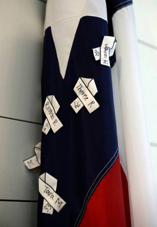 The names of victims hang on a Texas flag during a dedication ceremony for a new sanctuary and ...