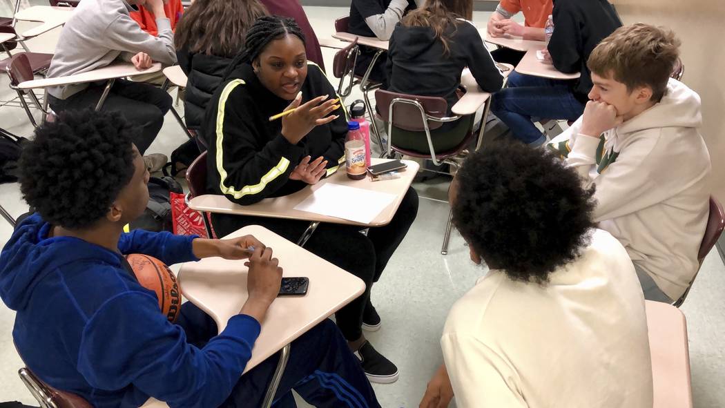 Sophomore Ramaya Wright, 15, second from left, leads a group making a list of the characteristi ...