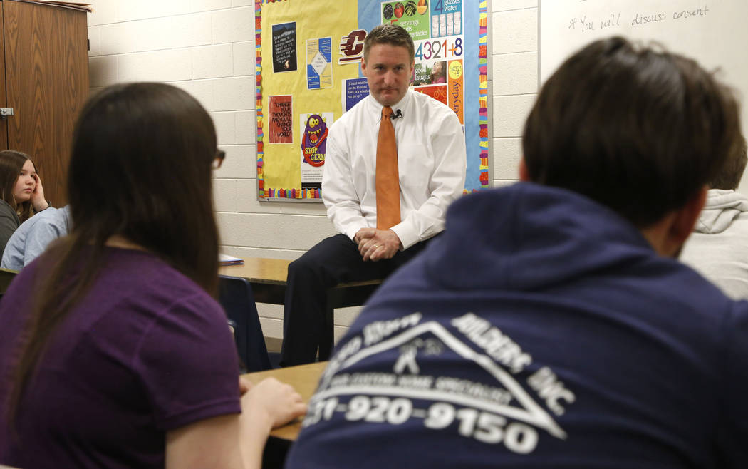 Jason Elmore, the prosecutor in Wexford County, Mich., listens to a student's question during a ...