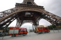 Rescue workers vehicles park just down the Eiffel Tower Monday, May 20, 2019 in Paris. The Eiff ...