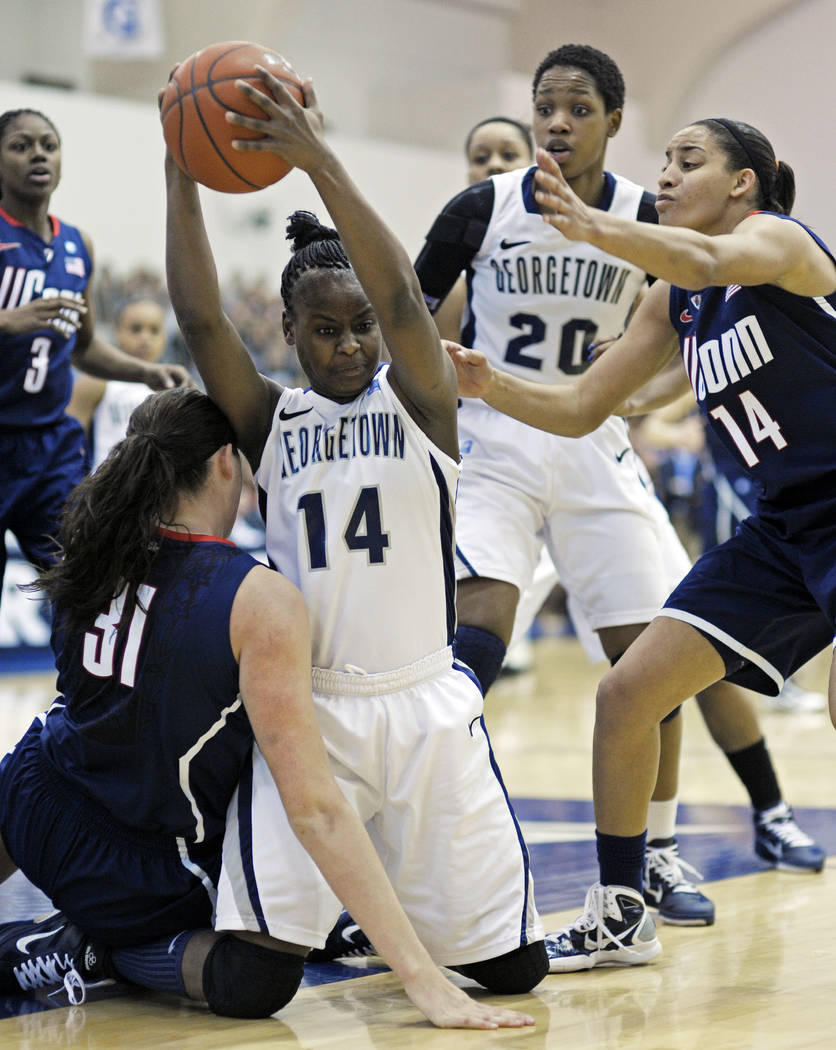 Georgetown guard Sugar Rodgers, 14, takes the ball away from Connecticut center Stefanie Dolson ...