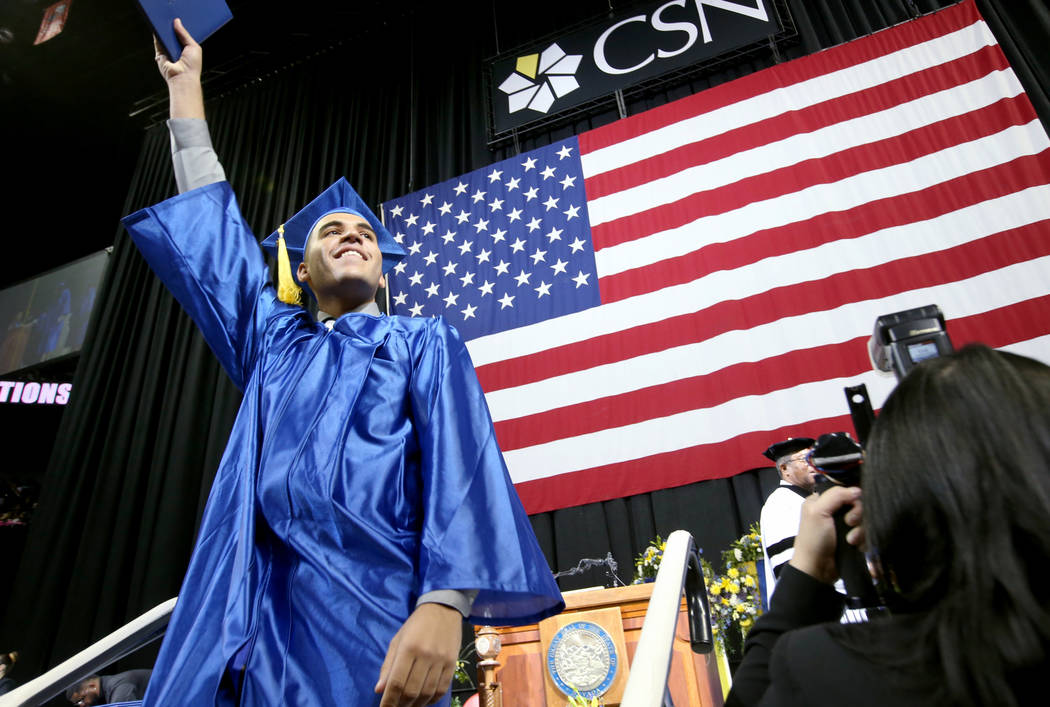 Edgar Vasquez-Santana waves to his family after walking across the stage during College of Sout ...