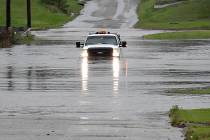 A pickup truck drives on a flooded street in Enid, Okla., Monday, May 20, 2019. An intense stor ...