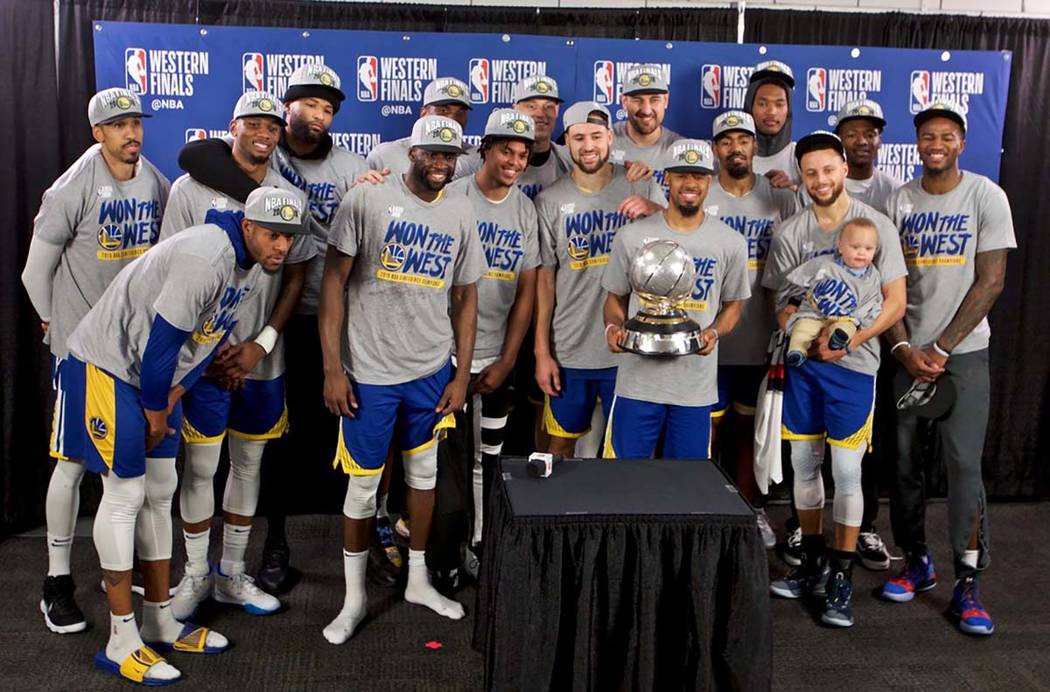 The Golden State Warriors players pose with the Western Conference Championship trophy after Ga ...