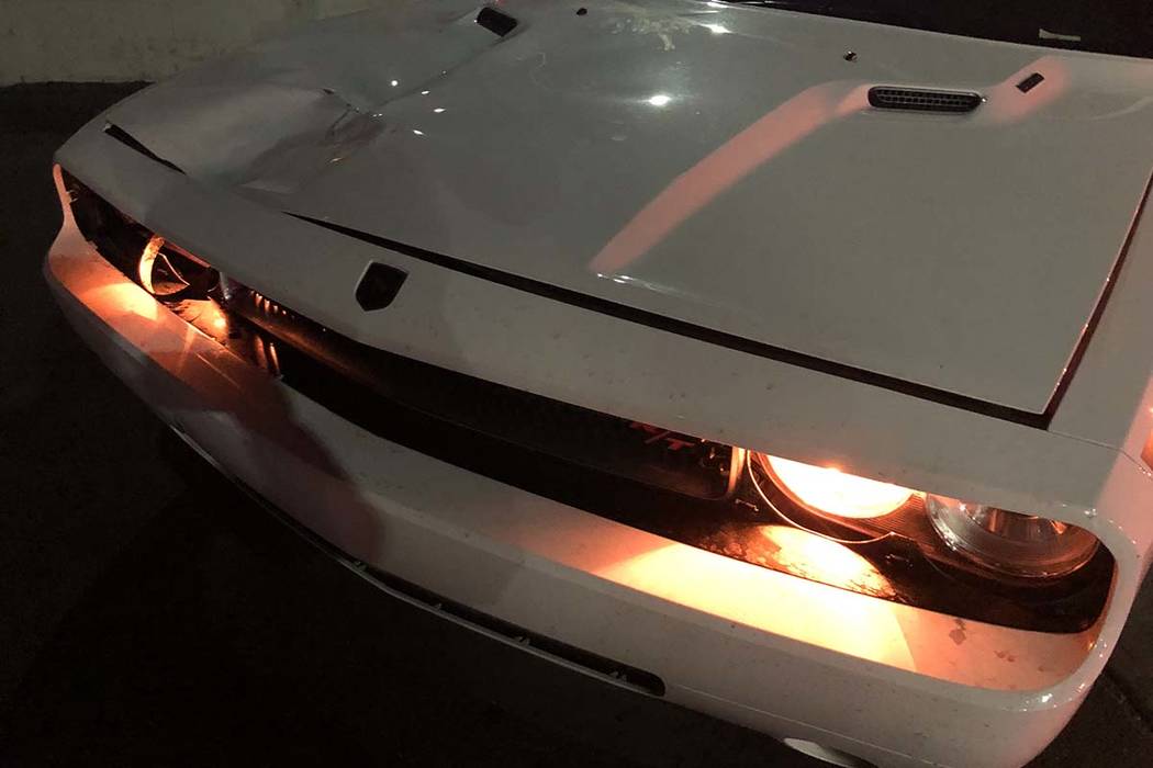 Front-end damage can be seen to a white Dodge Challenger that was driven by an off-duty Metropo ...