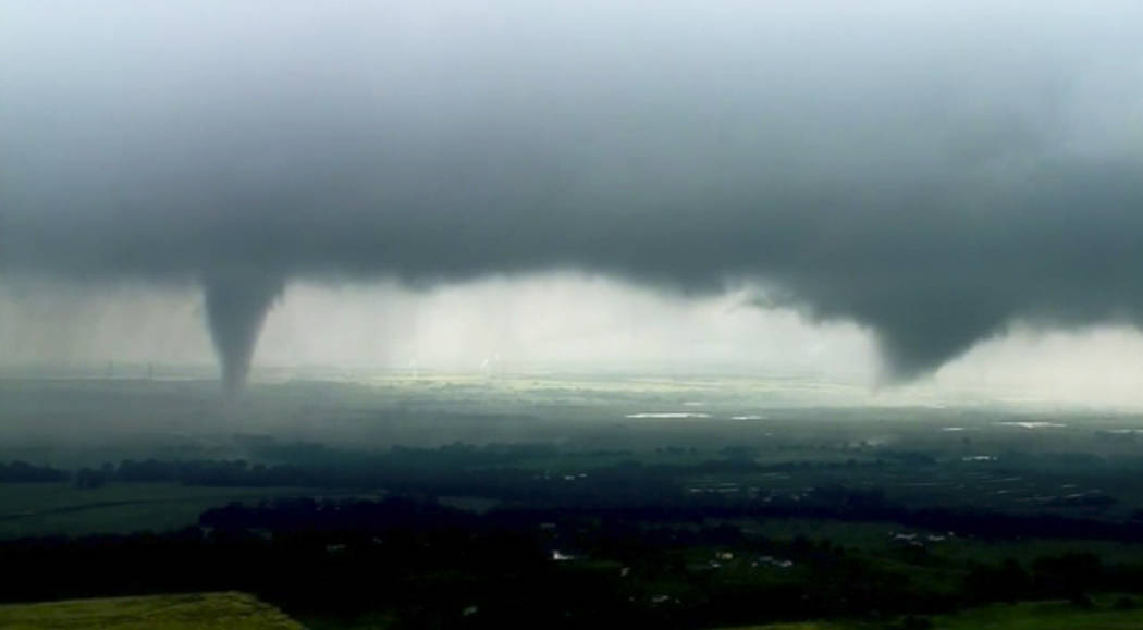 This image made from video provided by KWTV-KOTV shows two funnel clouds formed in Crescent, Ok ...