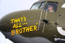 Pilot Tom Travis sits in the cockpit of the World War II troop carrier That's All, Brother duri ...