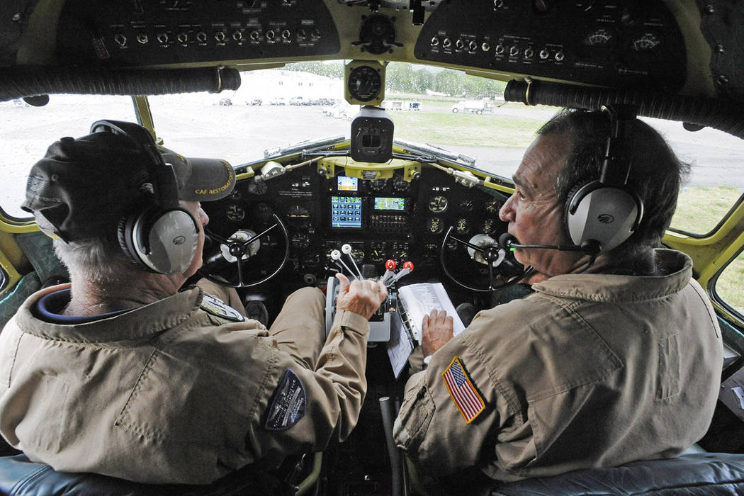 In this April 9, 2019, photo, Pilot Tom Travis, left, and Phil Bonasera sit at the controls of ...