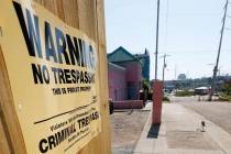 A "No Trespassing" sign is posted along the fencing protecting the parking lot of the ...