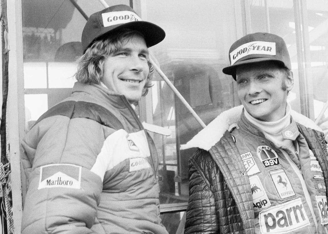 FILE - In this Oct. 24, 1976, file photo, Austrian auto racer Niki Lauda, right, defending cham ...