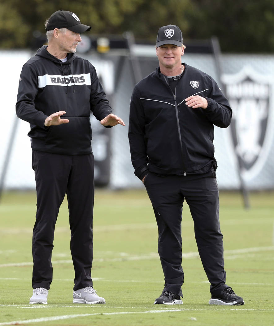 Oakland Raiders general manager Mike Mayock, left, and head coach Jon Gruden watch the team pra ...