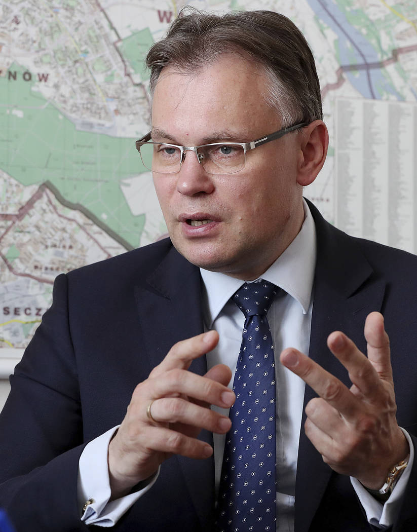 Poland's ruling party lawmaker Arkadiusz Mularczyk talks to The Associated Press in the parliam ...