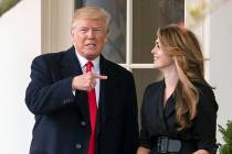 President Donald Trump points to outgoing White House Communications Director Hope Hicks on her ...