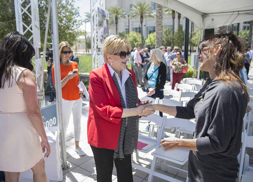 Mayor Carolyn Goodman, middle, shakes hands with artist Niki Sands during a ground breaking cer ...