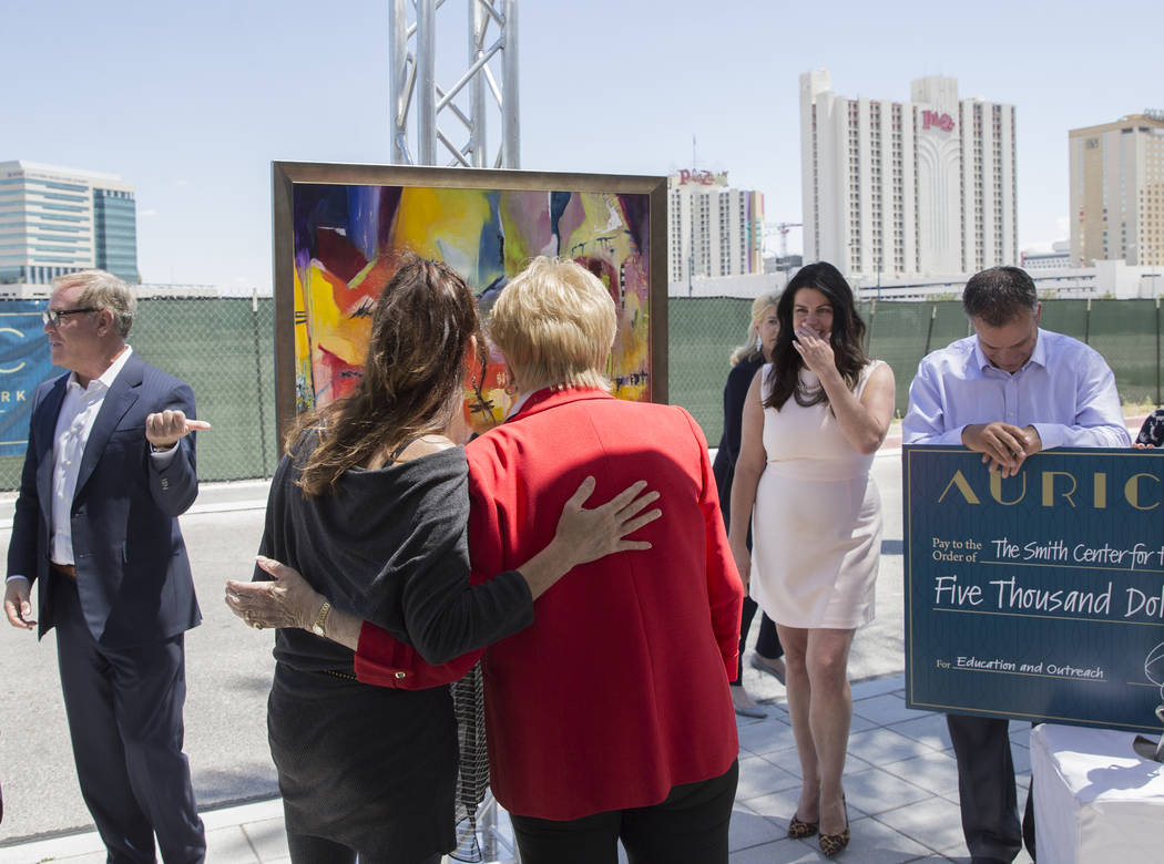 Mayor Carolyn Goodman, third from right, talks with artist Niki Sands about her painting during ...