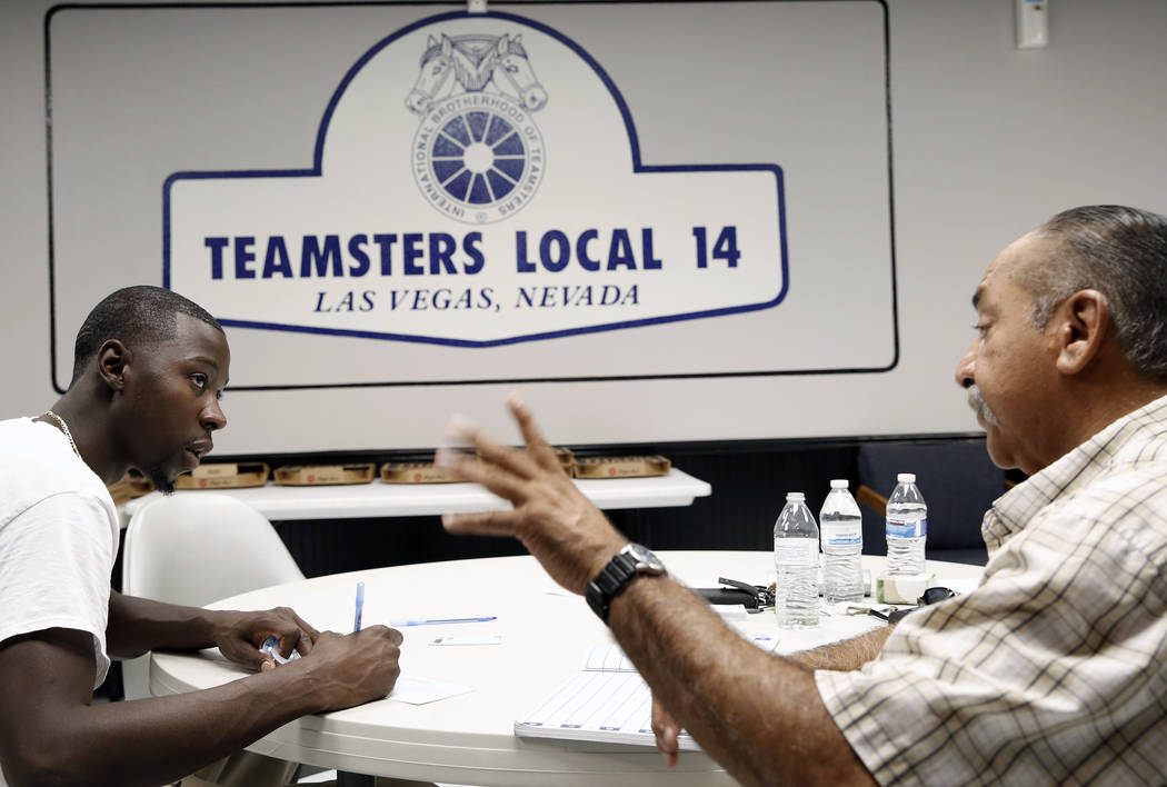 Ernie Ixtlahuac, right, Clark County School District Teamster activist, speaks to Larry Thomas ...
