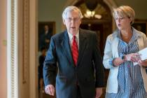 Senate Majority Leader Mitch McConnell, R-Ky., joined at right by aide Stefanie Hagar Muchow, w ...