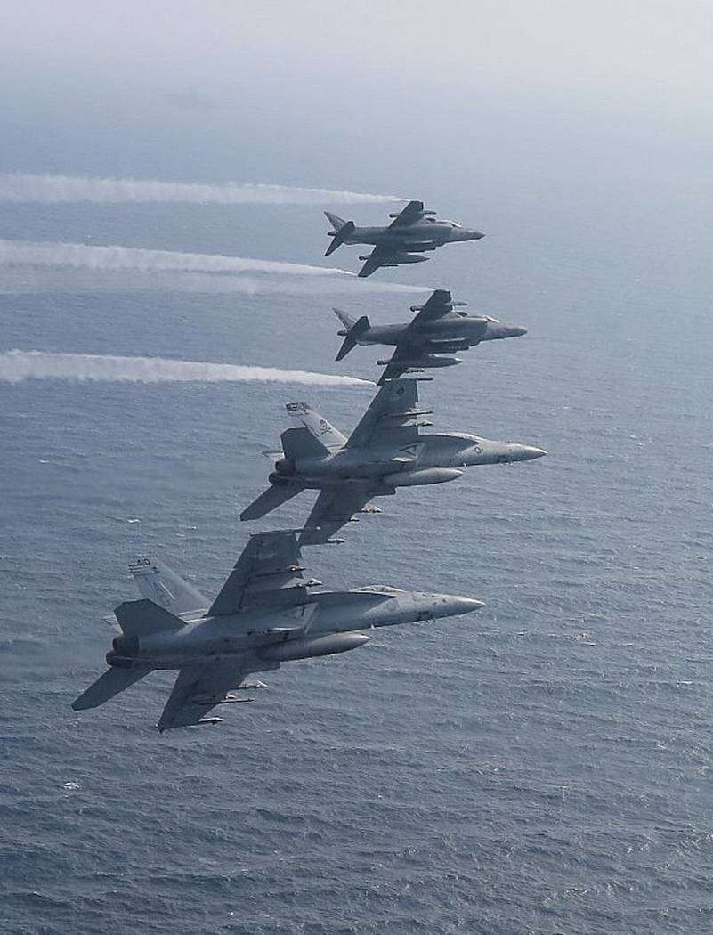 In this Saturday May 18, 2019, photo, two U.S. F/A-18E Super Hornets fly alongside two AV-8B Ha ...
