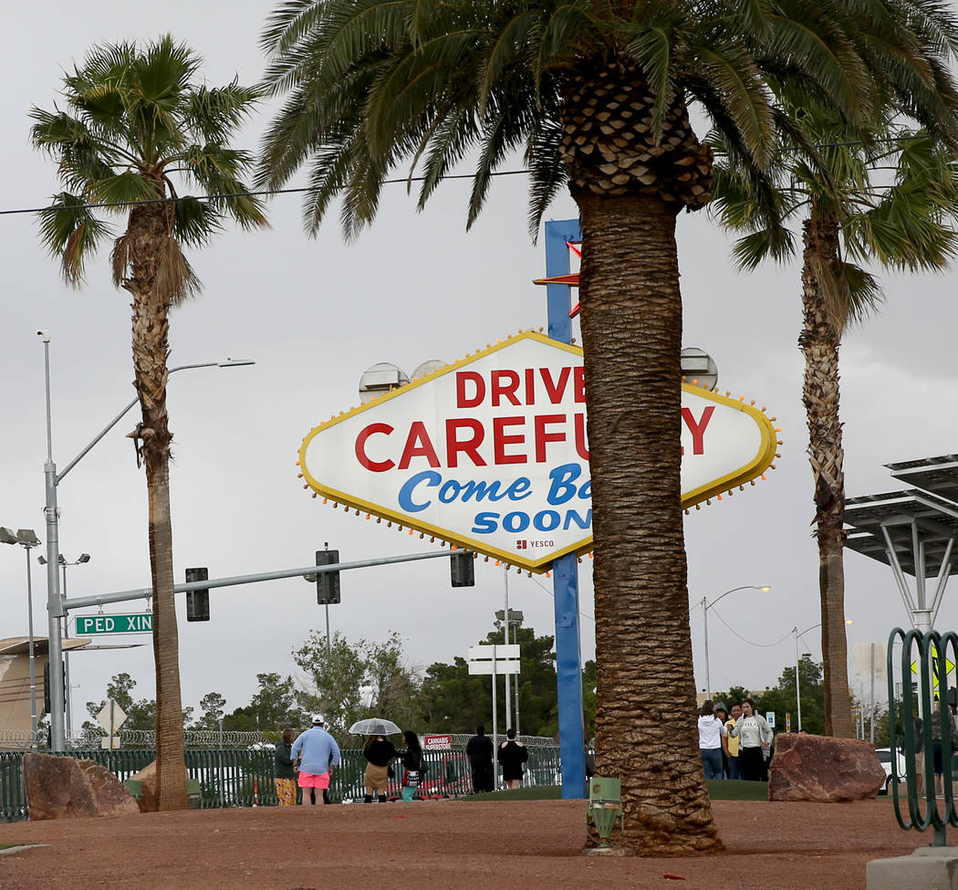 People take photos at the Welcome to Fabulous Las Vegas sign on the Strip Wednesday, May 22, 20 ...