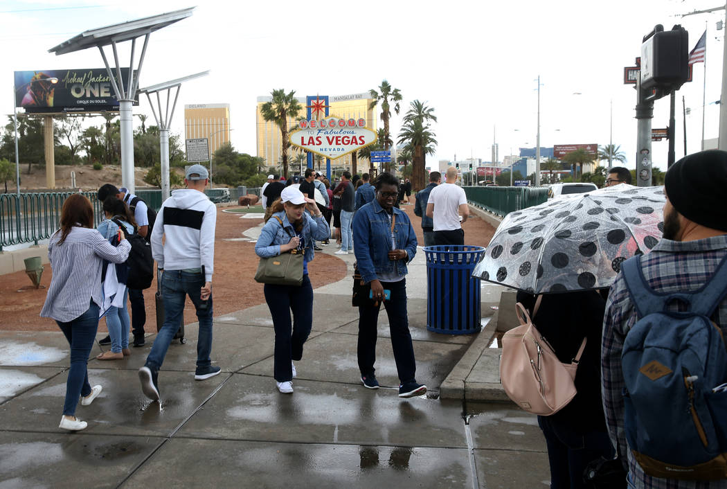 People take photos at the Welcome to Fabulous Las Vegas sign on the Strip Wednesday, May 22, 20 ...