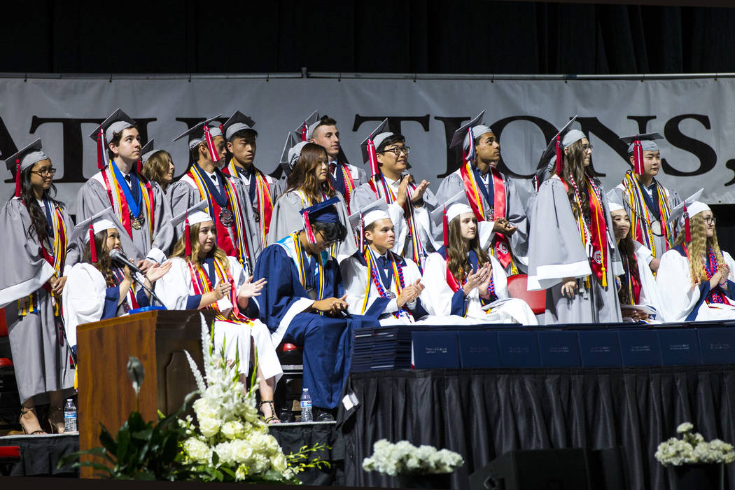 Graduating Coronado High School valedictorians, wearing gray robes, stand to be recognized duri ...