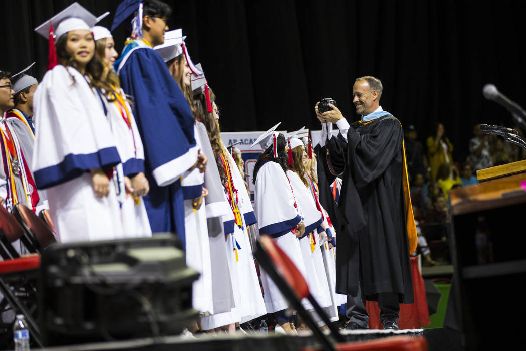 Coronado Principal Mike Piccininni, right, takes photos of students, including valedictorians, ...