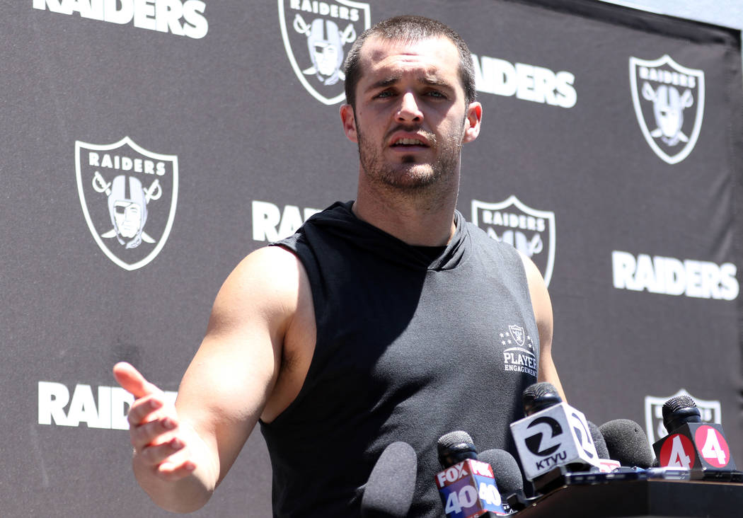 Oakland Raiders quarterback Derek Carr speaks to media after an offseason training session at t ...