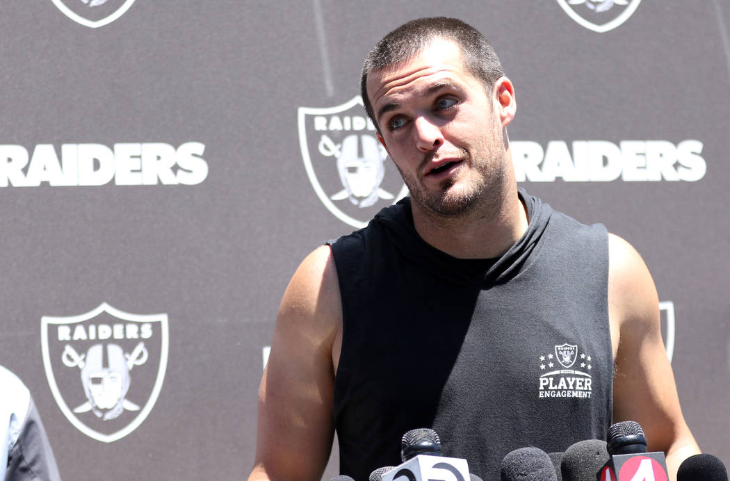 Oakland Raiders quarterback Derek Carr reacts to a question during a media scrum after an offse ...