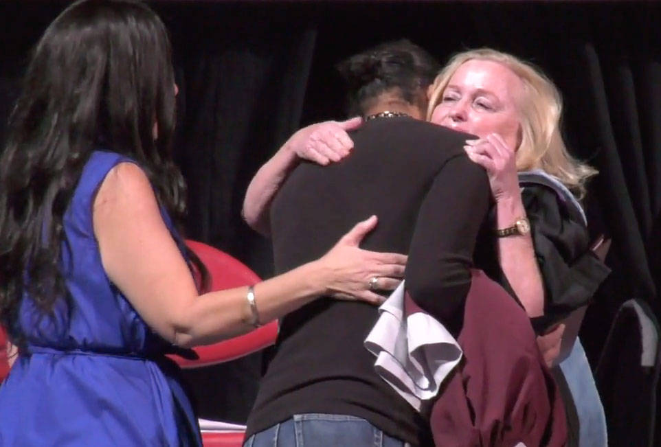 Christian Sigler hugs Cimarron-Memorial High School Principal Lori Lawson Sarabyn after receivi ...
