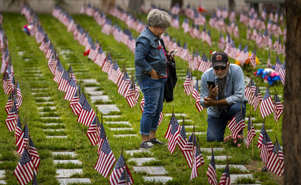 Pamela and Michael Wages pay tribute to his parents Eldoris and Betty Wages buried there on Mem ...