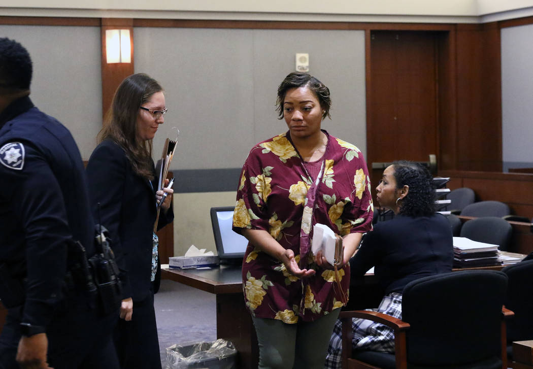 Cadesha Bishop, 25, right, accused of shoving a 74-year-old man off a bus, leaves the courtroom ...